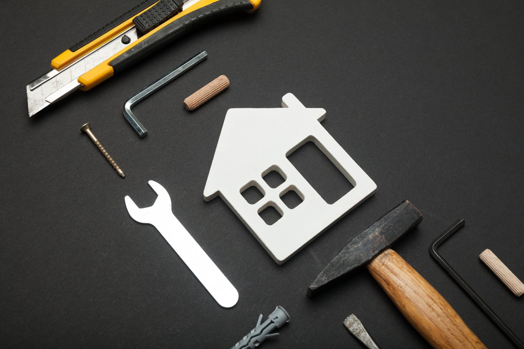 tools used in the construction of a house on a black background